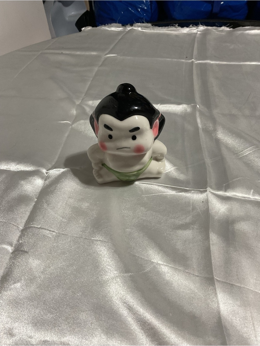 Ceramic Figurine with Black Hair and Green Sash